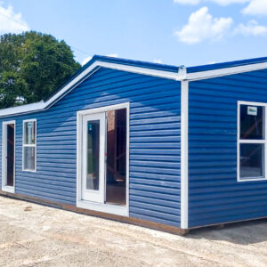 exterior of blue double wide tiny home shell