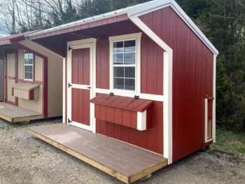 A red backyard chicken house for sale in Tennessee with a porch