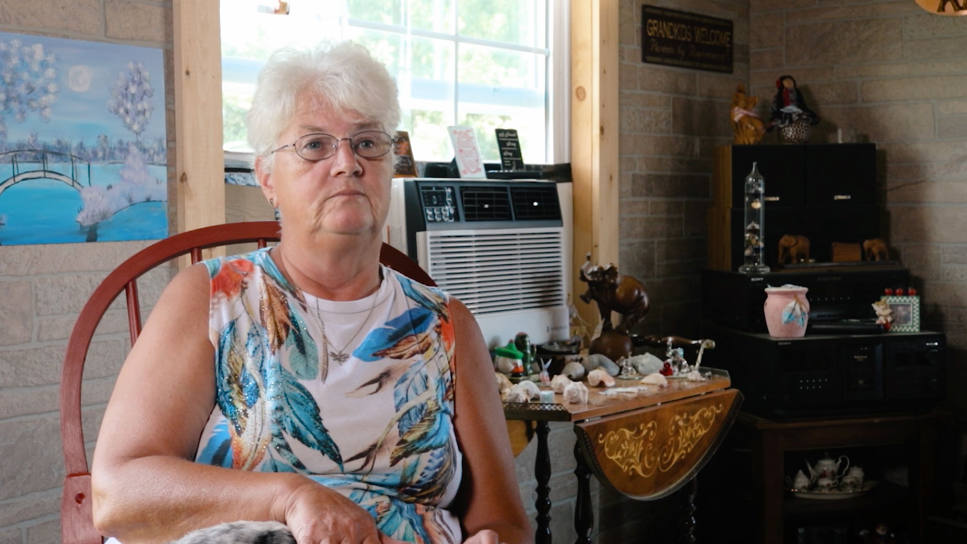 deborah whitlaw sitting in her modular cabin for sale