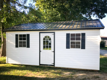 A garage shed in Tennessee with vinyl siding and two windows