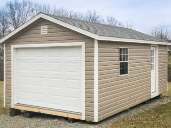 A garage shed in Tennessee with vinyl siding and a shingle roof