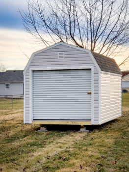 A prefab garage in Kentucky with vinyl siding and a roll-up door