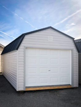 A prefab garage in Tennessee with vinyl siding and a black metal roof