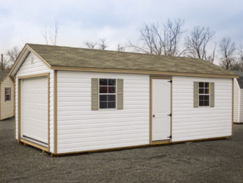 A portable garage in Kentucky with vinyl siding and a shingle roof