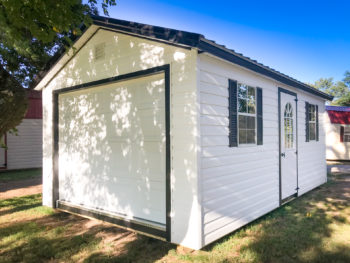 A small portable garage in Tennessee with white vinyl siding and two windows