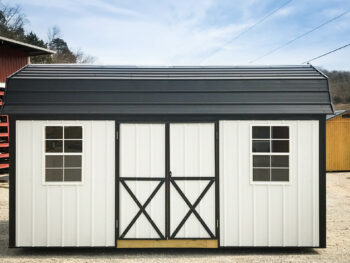 A white backyard shed with windows.