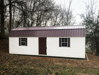 White vinyl shed with a metal roof in Kentucky.