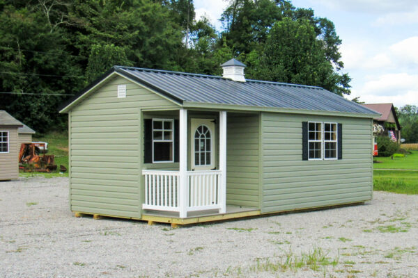 A green she shed ranch cabin