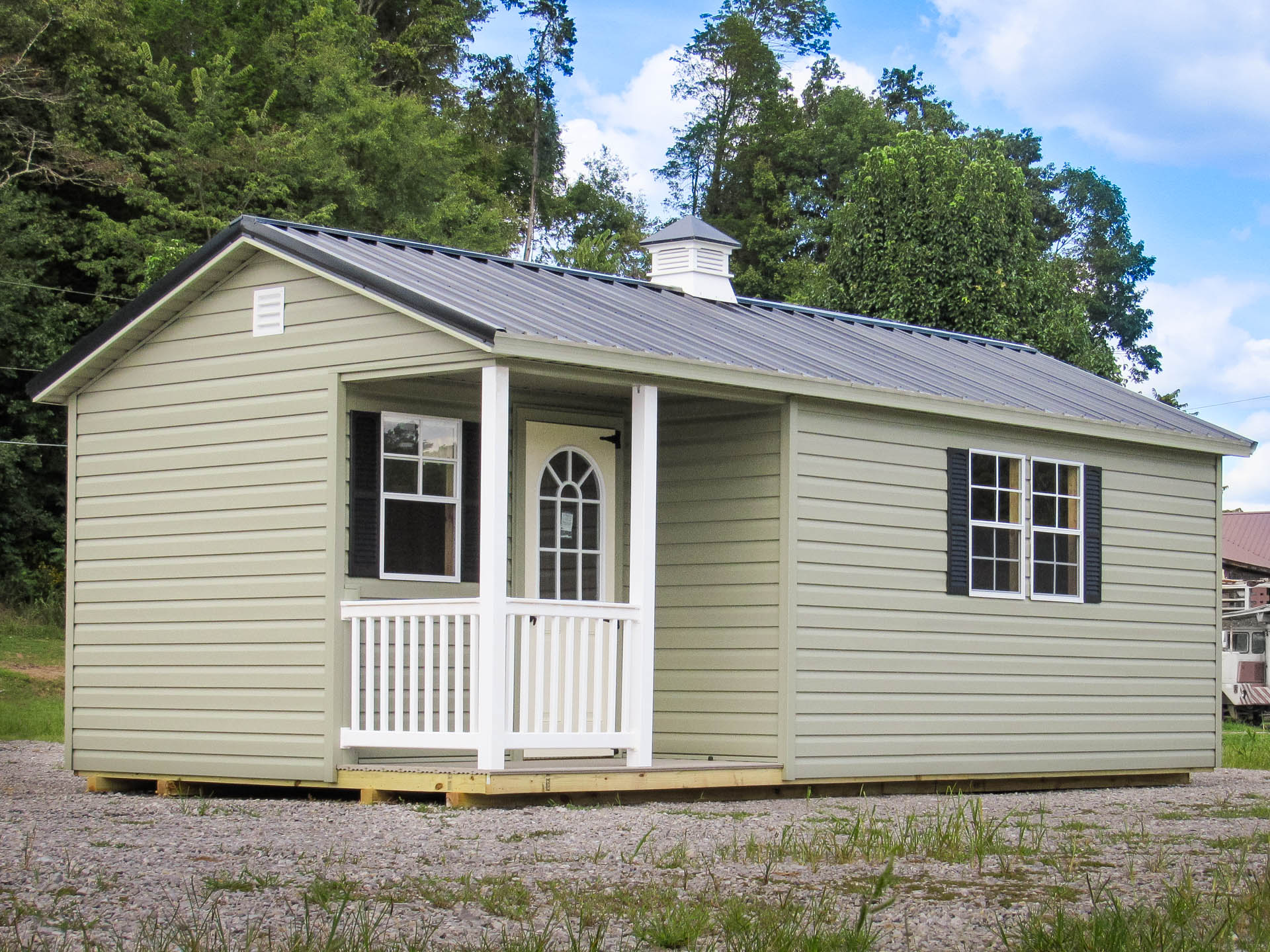 An office shed with a cupola and porch.