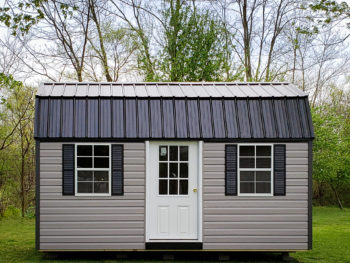 An outdoor shed in Kentucky with vinyl siding and a black metal roof