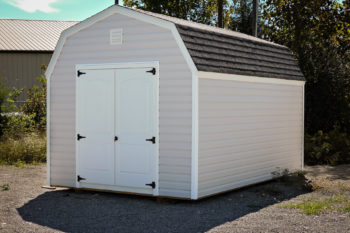 A storage building in Kentucky with vinyl siding and a shingle roof