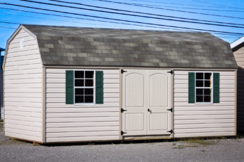 A prefab storage building in Kentucky with vinyl siding and two windows