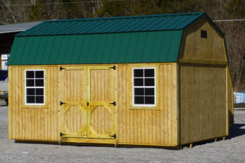 A prefab lofted storage building in Kentucky with wood siding and double doors