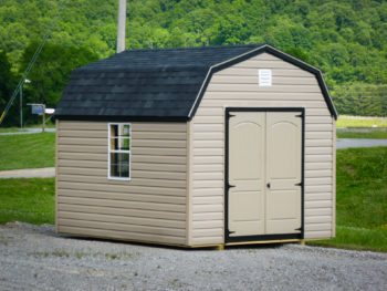 A storage building in Kentucky with vinyl siding and a black shingle roof