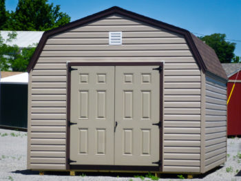 A prefab storage building in Kentucky with brown vinyl siding and double doors