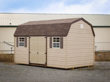 A storage building in Kentucky with vinyl siding and a brown shingle roof