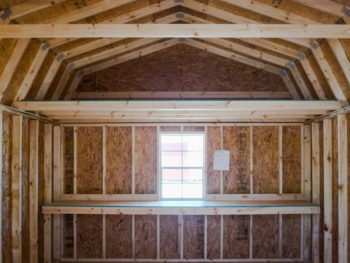 Interior of a storage building in Tennessee with a loft and a shelf