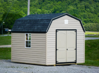 A prefab storage building in Tennessee with vinyl siding and a black shingle roof