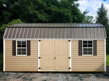 A storage building in Tennessee with brown vinyl siding and double doors