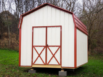 A prefab storage building in Tennessee with metal siding and a red metal roof