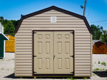 A lofted prefab storage building in Tennessee with vinyl siding and double doors