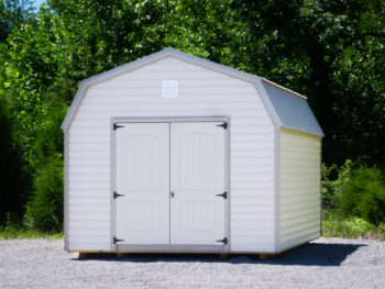 A prefab lofted storage building in Tennessee with vinyl siding and double doors