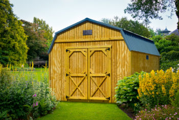 A lofted storage building in Tennessee with wood siding and double doors