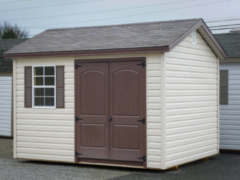 A shed in Kentucky with vinyl siding and brown double doors