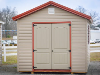 A shed in Kentucky with vinyl siding and a red metal roof