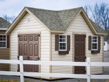 A shed in Kentucky with vinyl siding and a shingle roof with a dormer