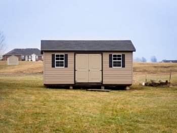 A vinyl shed in Kentucky with a shingle roof and double doors