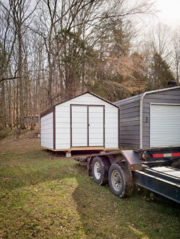 A vinyl shed with metal siding being delivered in Kentucky