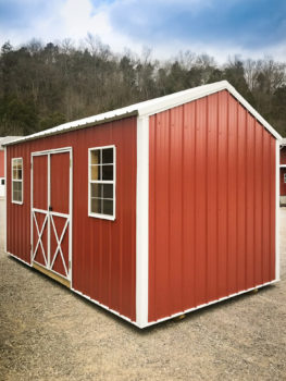 A metal shed in Kentucky with double doors and windows