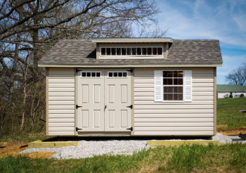 A vinyl shed in Kentucky with double doors, windows, and a roof dormer