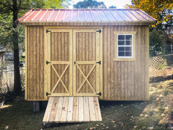 A wooden shed in Kentucky with double doors and a ramp