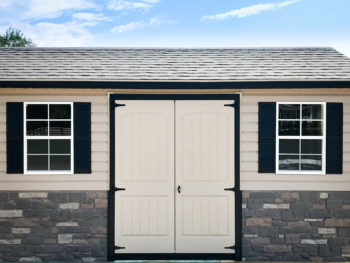 A customized shed in Tennessee with vinyl siding and double doors