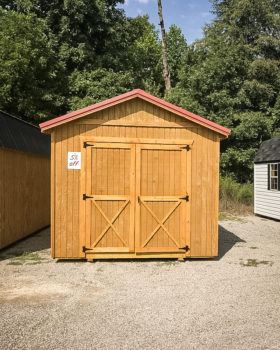 A discounted shed in Tennessee with wooden siding and a red metal roof