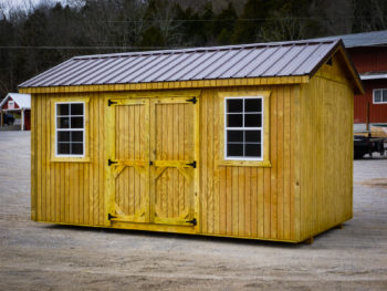 A wooden shed in Tennessee with double doorsand windows