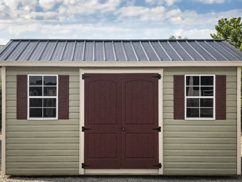 A shed in Tennessee with green vinyl siding and a metal roof