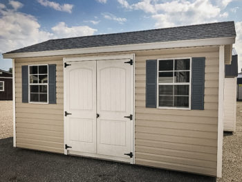 A shed in Tennessee with vinyl siding and a shingle roof