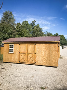 A shed in Tennessee with wooden siding, a window, and a metal roof