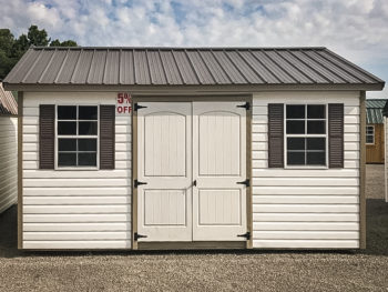 A discounted shed in Tennessee with white vinyl siding and a metal roof