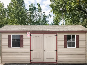 A discounted shed in Tennessee with vinyl siding and double doors