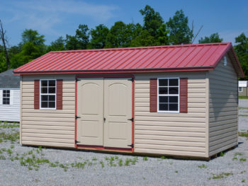 A vinyl shed in Tennessee with double doors, windows, and shutters