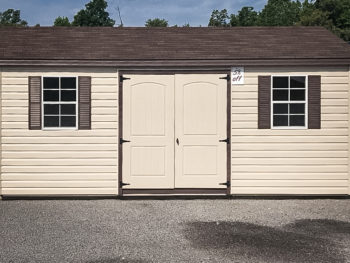 A discounted shed in Tennessee with vinyl siding, windows, and a double door