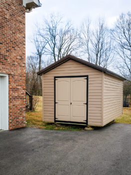 A delivered shed in Tennessee with vinyl siding and double doors