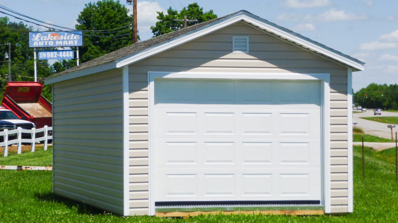 exterior of tan and white prefab detached garage for sale