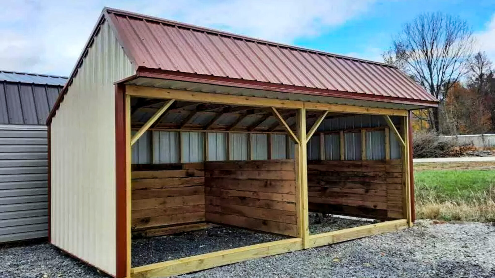 exterior of maroon and tan shed for loafing barn for sale article