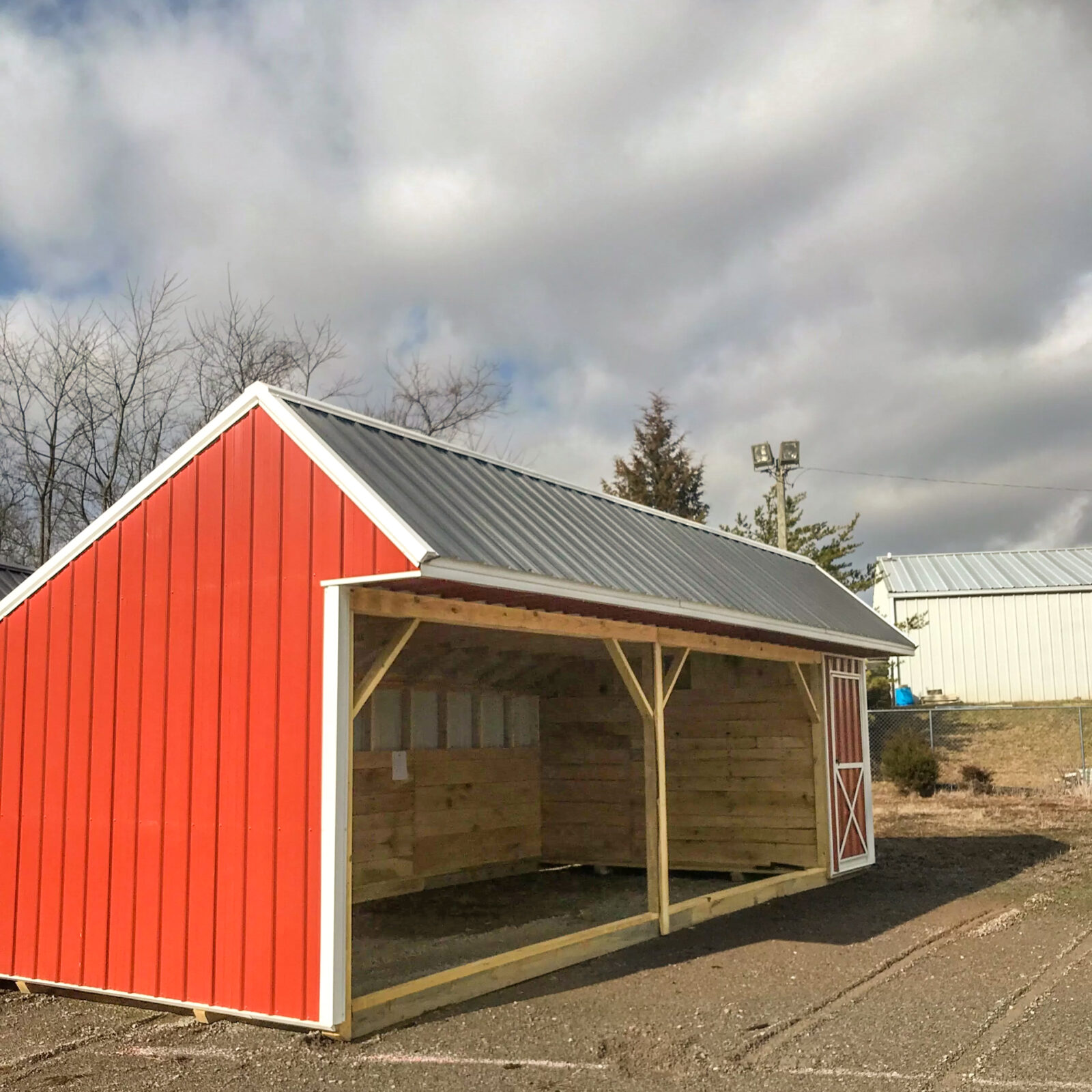 exterior of red and white loafing shed for sale