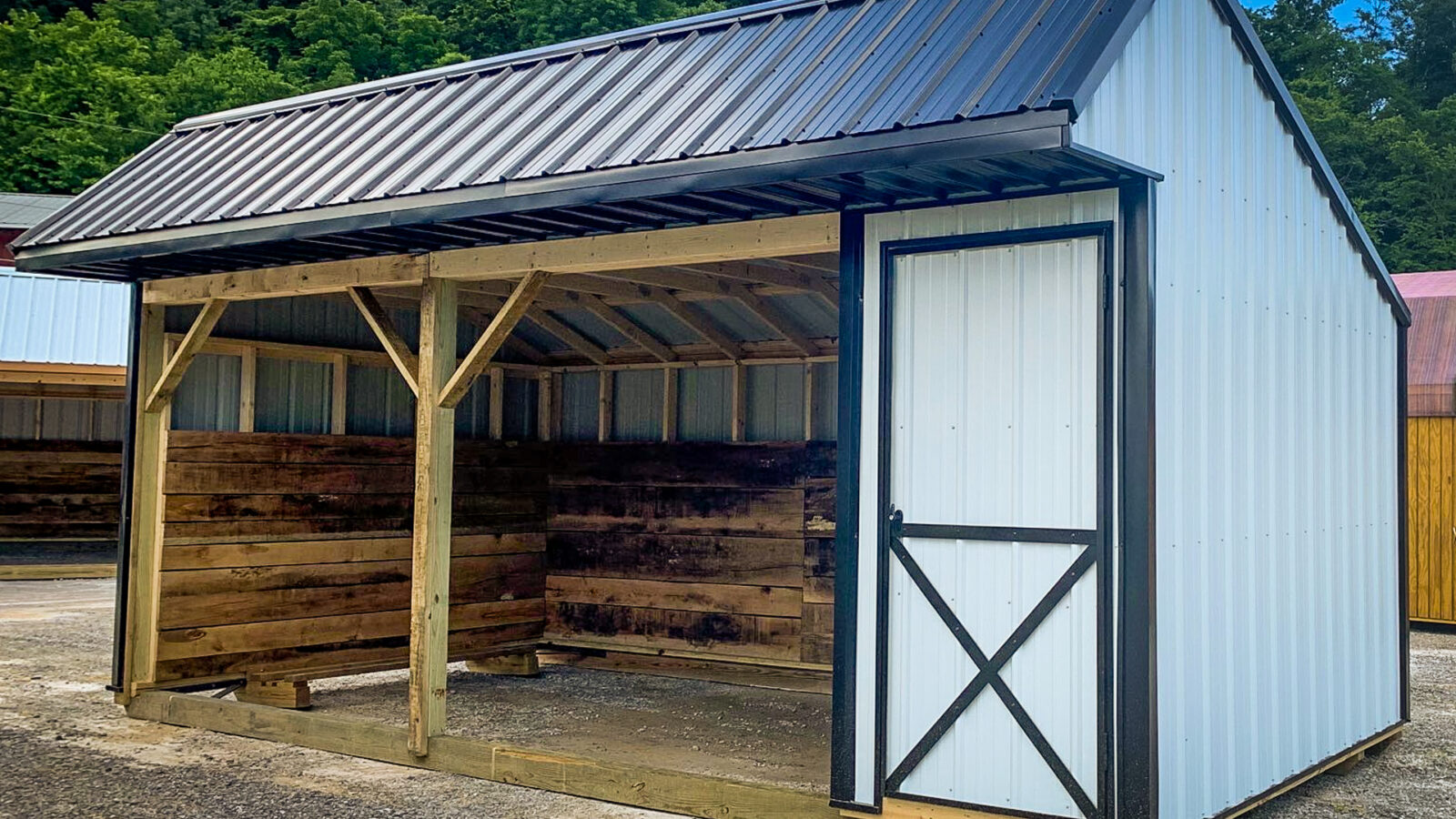 exterior of black and white loafing shed for sale